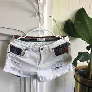 Embroidered white distressed denim shorts